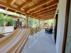 a porch with hammocks on a house at Spondylus Lodge in Ayampe