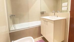 a bathroom with a toilet and a sink and a shower at Marais Recoleta in Buenos Aires +110 photos