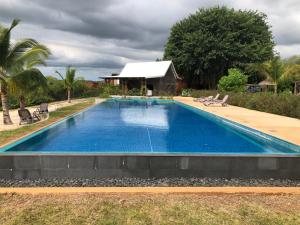 a swimming pool in front of a house at Picturesque Riverside 2-Bedroom Ensuite Villa in Port Chambly in Terre Rouge