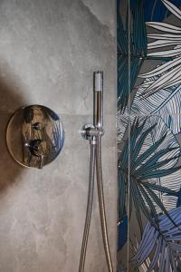 a shower head in a bathroom next to a wall at Ca' dela Stazion in Verona