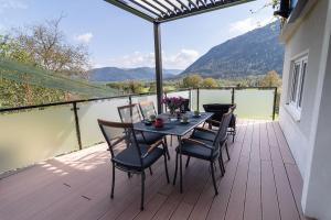 a table and chairs on a balcony with a view at Panorama 13 in Tolmin