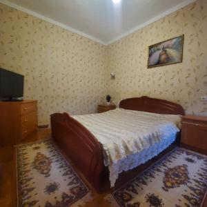 um quarto com uma cama e uma TV em Квартира-apartament em Tiraspol