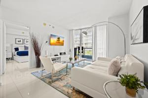 a white living room with a white couch and chairs at Luxury 1 BR Condo W Icon Brickell-Waterviews in Miami