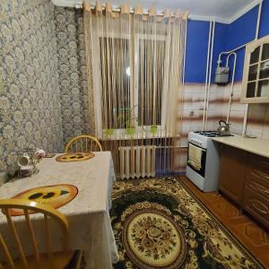uma cozinha com mesa e cadeiras em uma sala em Квартира-apartament em Tiraspol