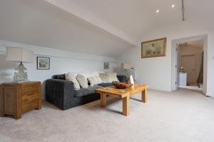 a living room with a couch and a coffee table at The Amazing Attik Apartment in Skipton