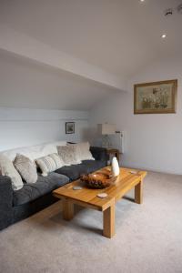 a living room with a couch and a coffee table at The Amazing Attic Apartment in Skipton