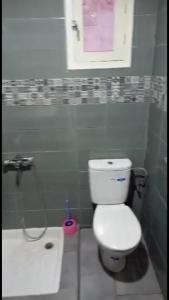 a bathroom with a white toilet and a sink at Appartement à ALHOCEIMA in Al Hoceïma