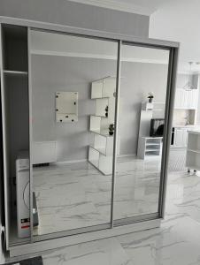 a room with a sliding glass door and a kitchen at Crown Plaza Park Luxury Apartment in Chişinău +25 photos