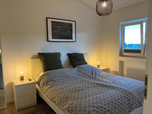 a bedroom with a bed and a window and lights at Landhaus 918 in Koosbüsch