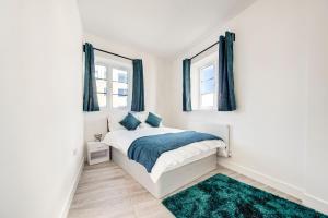 1 dormitorio con 1 cama y 2 ventanas en 2 bedroom apartment with large rooms and Wi-Fi, en Londres