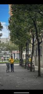 Ein Mann schiebt sein Fahrrad auf einer Stadtstraße in der Unterkunft Loyola Family&Friends in Loyola