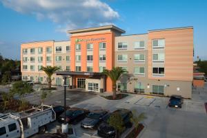 an office building with cars parked in a parking lot at Holiday Inn Express & Suites - Hawaiian Gardens, an IHG Hotel in Hawaiian Gardens