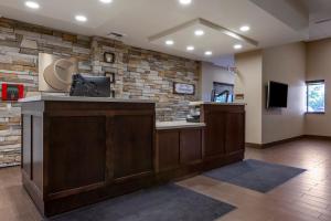a lobby with a reception desk and a stone wall at MainStay Suites Coeur d'Alene in Coeur d'Alene