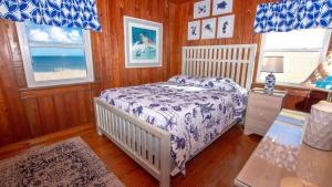 a bedroom with a bed and two windows at OCEANFRONT, Ocean views, Dogs Welcome! KH10, Beach House in Kitty Hawk