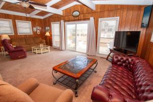 a living room with a couch and a tv at Oceanside, Sun Deck, Close to beach! KH106, Annie Oakley in Kitty Hawk