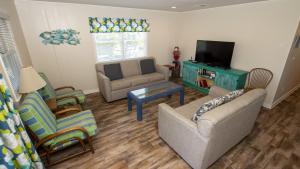 a living room with two couches and a tv at KH146, Camelot- Oceanside, Screened Porch, Close to Shopping and Restaurants! in Kitty Hawk