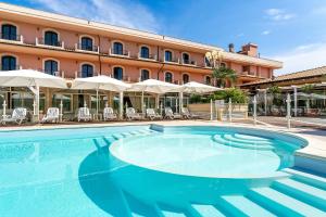 a large swimming pool in front of a hotel at Hotel Villa Elena in Tortoreto Lido