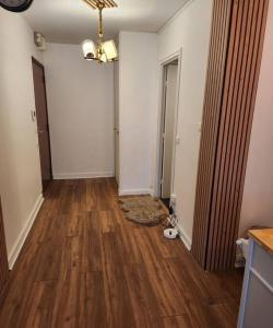 an empty room with a hard wood floor and a hallway at Appartement La Défense in Puteaux