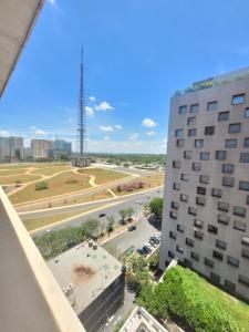 a view of a city from a building at Brasília By Rei dos Flats in Brasília