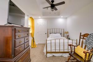 Schlafzimmer mit einem Bett, einer Kommode und einem Deckenventilator in der Unterkunft Charming Country Cottage in Goodspring! in Pulaski
