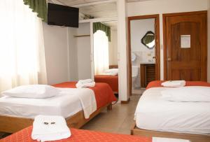 Postel nebo postele na pokoji v ubytování Hotel Colonial