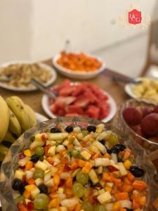 a table topped with plates of different types of food at Hotel central campo grande in Campo Grande