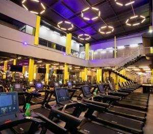 a gym with rows of treadmills and machines at Flat Luxo Jardim Goiás in Goiânia