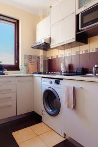 a kitchen with a washing machine in a kitchen at Studio @ Arena Națională Stadium in Bucharest