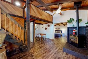 a living room with a fireplace and wooden ceilings at Hilltop Lodge in Stateline