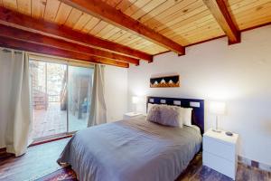 a bedroom with a large bed and a large window at Hilltop Lodge in Stateline