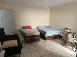 a living room with two beds and a couch at 204 apartamento verão ideal para você in Brasilia