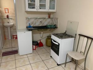 a small kitchen with a stove and a sink at 204 apartamento verão ideal para você in Brasilia