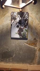 a picture of a tree on the side of a wall at Hostal el patio restaurante in San Bartolomé de Pinares