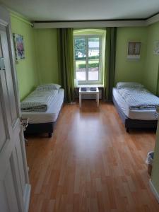 a room with two beds and a window at Gasthof Feische in Hellefeld