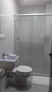 a bathroom with a toilet and a shower and a sink at Pousada Essência Serrana Gramado in Gramado