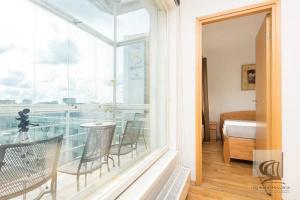 Habitación con balcón con mesa y sillas. en Cozy 2-Bedroom Penthouse in the Heart of Tallinn en Tallin
