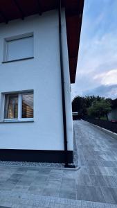 a white building with a window on the side of it at NewEra Apartment 1 