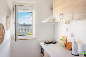 a kitchen with a counter top with a window at Premium Studio next to National Arena & Park in Bucharest