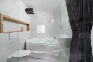 a bathroom with a toilet a sink and a shower at Motzkin sweet in Qiryat Motzkin