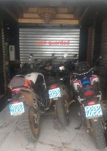 two motorcycles parked in front of a garage at Hotel LAHLOU riad Cafeteria in Oujda