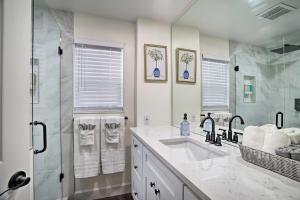 a white bathroom with a sink and a shower at Lovely Redmond Home about 17 Mi to Downtown Seattle! in Redmond