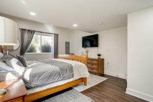 a bedroom with a bed and a desk and a window at Lovely Redmond Home about 17 Mi to Downtown Seattle! in Redmond