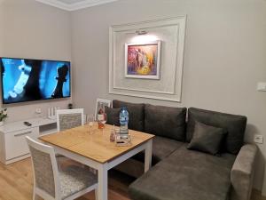 a living room with a couch and a table at Family Boutique Residence-Free parking in Veliko Tŭrnovo