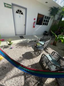 a hammock in front of a house at Brisa del mar Holbox in Holbox Island +2 photos