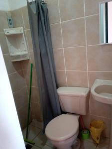 a bathroom with a toilet and a sink at Casa Sayana in Samaipata