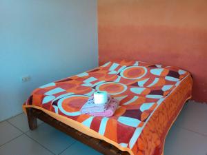 a small bed with a coffee cup on top of it at Casa Sayana in Samaipata