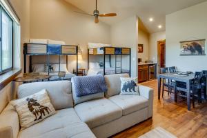 a living room with a couch and two bunk beds at Angel Fire Home with Hot Tub Less Than 1 Mi to Ski Slopes! in Angel Fire