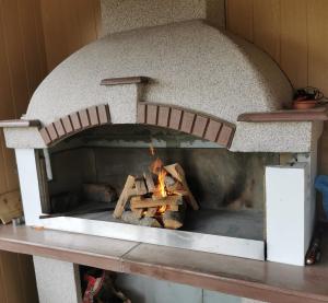 a brick oven with a fire inside of it at Planinski Mir in Zaovine
