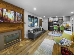 a living room with a fireplace and a tv at Park City Gem at Red Pine! Cozy Ski Condo with Heated Pools and Hot Tubs! B4 condo in Park City