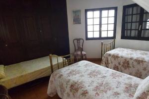 a bedroom with two beds and a window at Finca David Galdar in Las Palmas de Gran Canaria